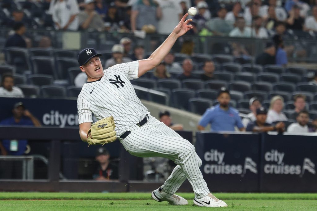 Aug 13, 2025; Bronx, New York, USA; New York Yankees relief pitcher Brent Headrick (47) attempts to the throws the ball to first base during the ninth inning against the Minnesota Twins at Yankee Stadium. Mandatory Credit: Vincent Carchietta-Imagn Images