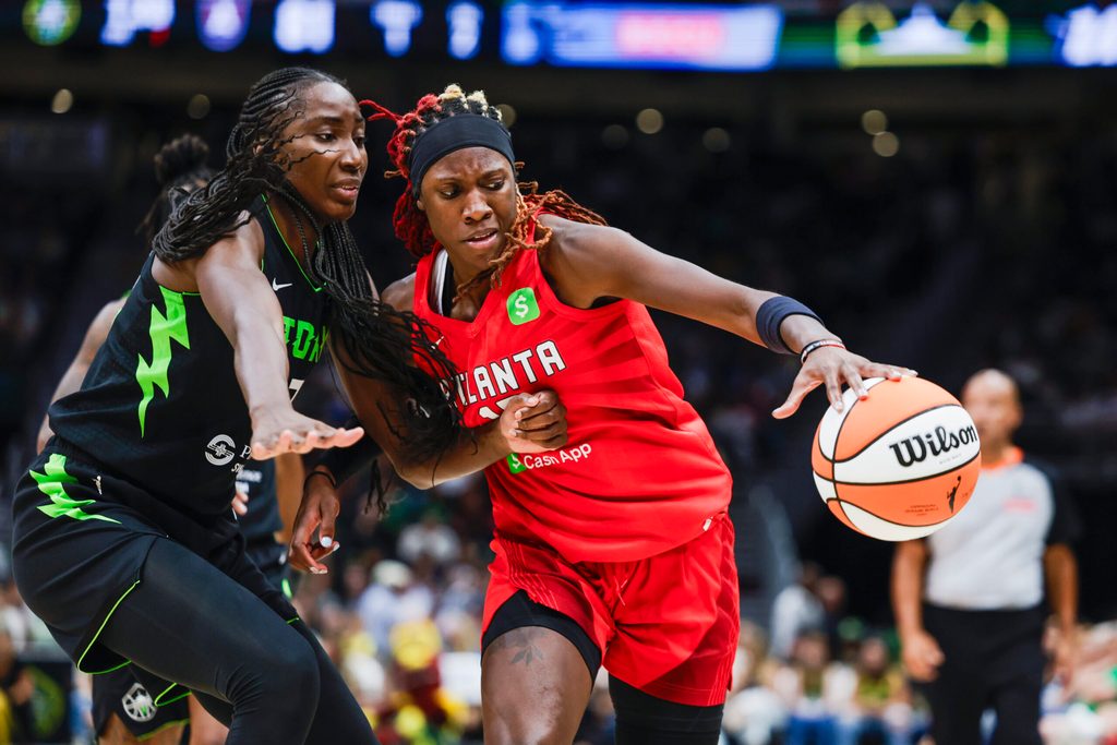 Aug 13, 2025; Seattle, Washington, USA; Atlanta Dream guard Rhyne Howard (10) dribbles against Seattle Storm forward Ezi Magbegor (13) during the fourth quarter at Climate Pledge Arena. Mandatory Credit: Joe Nicholson-Imagn Images