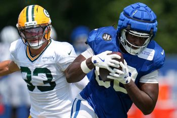 Green Bay Packers safety Evan Williams (33) attempts to take down Indianapolis Colts tight end Jelani Woods (80) on Thursday, Aug. 14, 2025, at a joint practice during Indianapolis Colts’ training camp at Grand Park in Westfield.