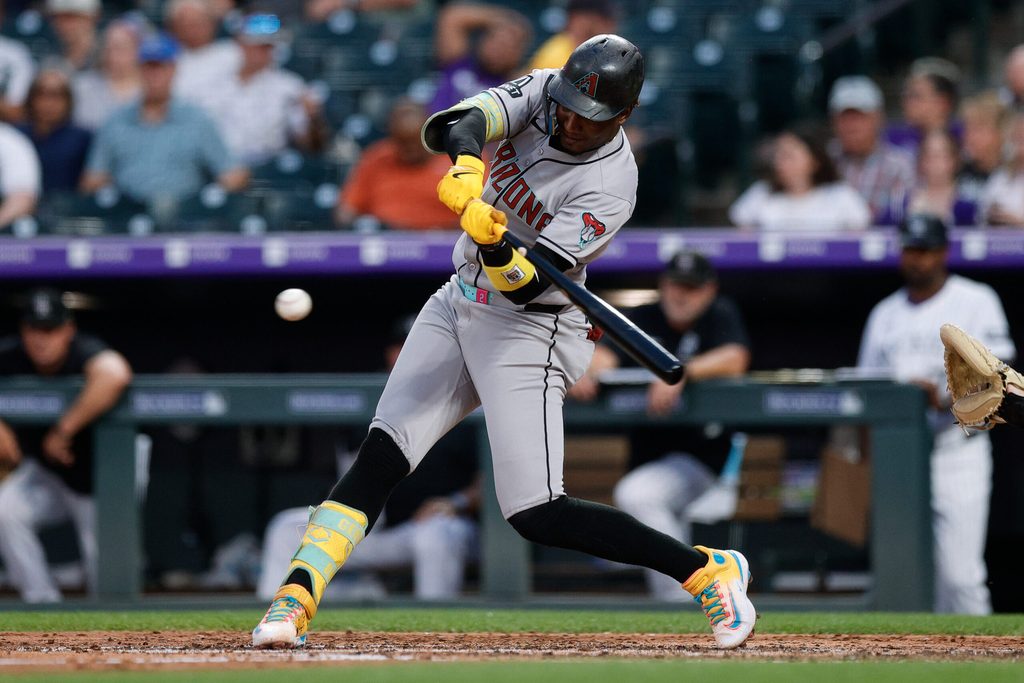 Aug 14, 2025; Denver, Colorado, USA; Arizona Diamondbacks shortstop Geraldo Perdomo (2) hits a single in the fourth inning against the Colorado Rockies at Coors Field. Mandatory Credit: Isaiah J. Downing-Imagn Images