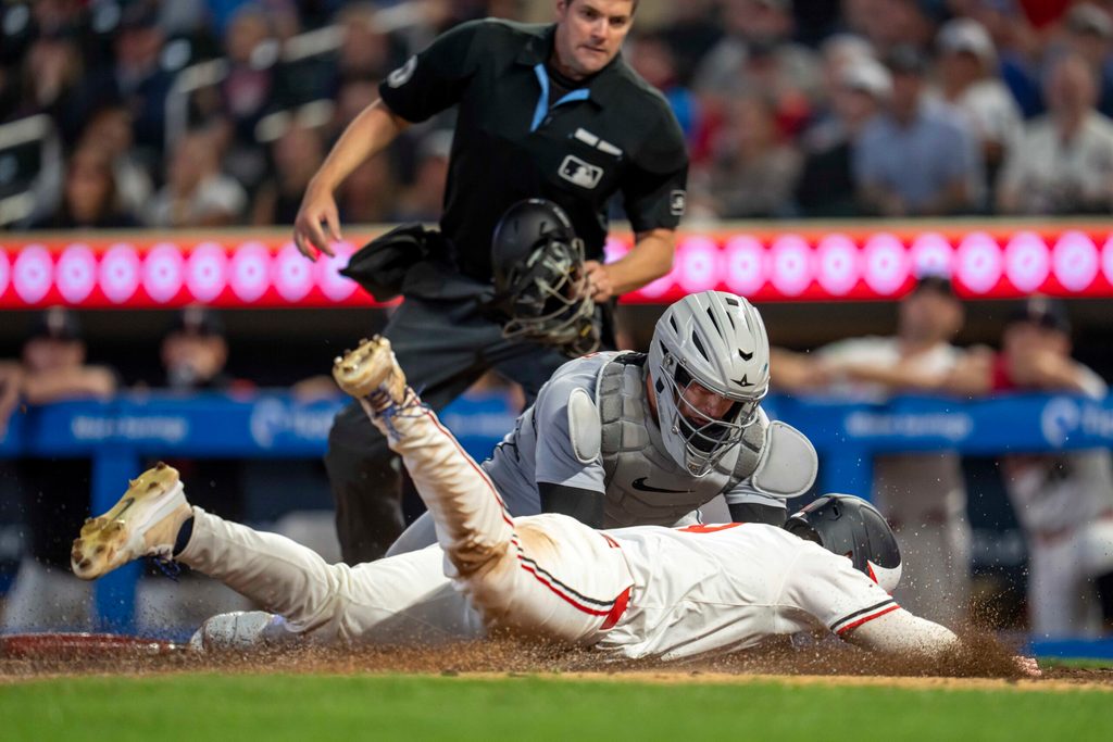 Aug 14, 2025; Minneapolis, Minnesota, USA; Detroit Tigers catcher Dillon Dingler (13) tags out Minnesota Twins left fielder Alan Roden (19) at home plate in the tenth inning at Target Field. Mandatory Credit: Jesse Johnson-Imagn Images