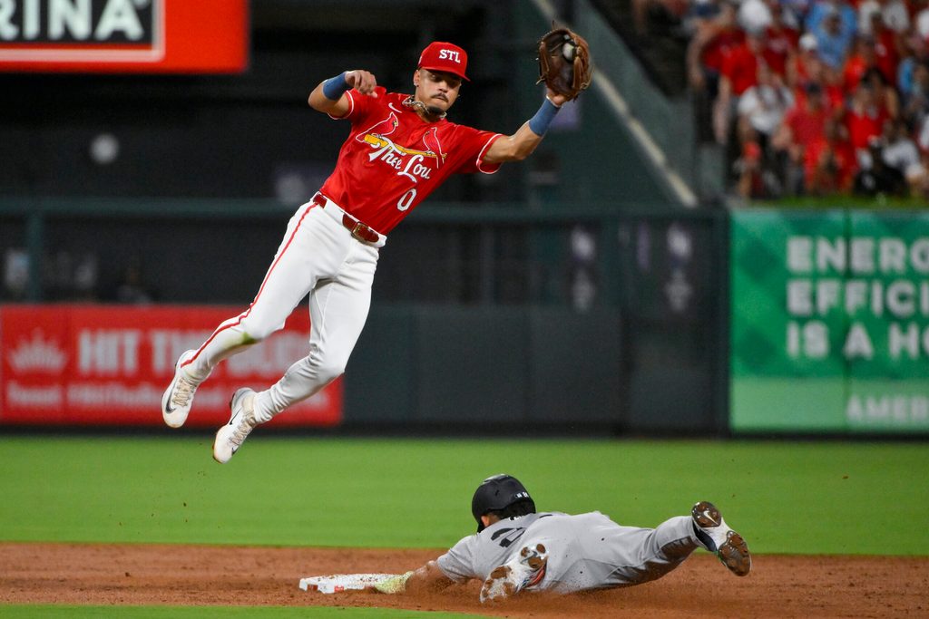 Aug 15, 2025; St. Louis, Missouri, USA; St. Louis Cardinals shortstop Masyn Winn (0) leaps to field the throw and tags out New York Yankees left fielder Jasson Dominguez (24) during the third inning at Busch Stadium. Mandatory Credit: Jeff Curry-Imagn Images
