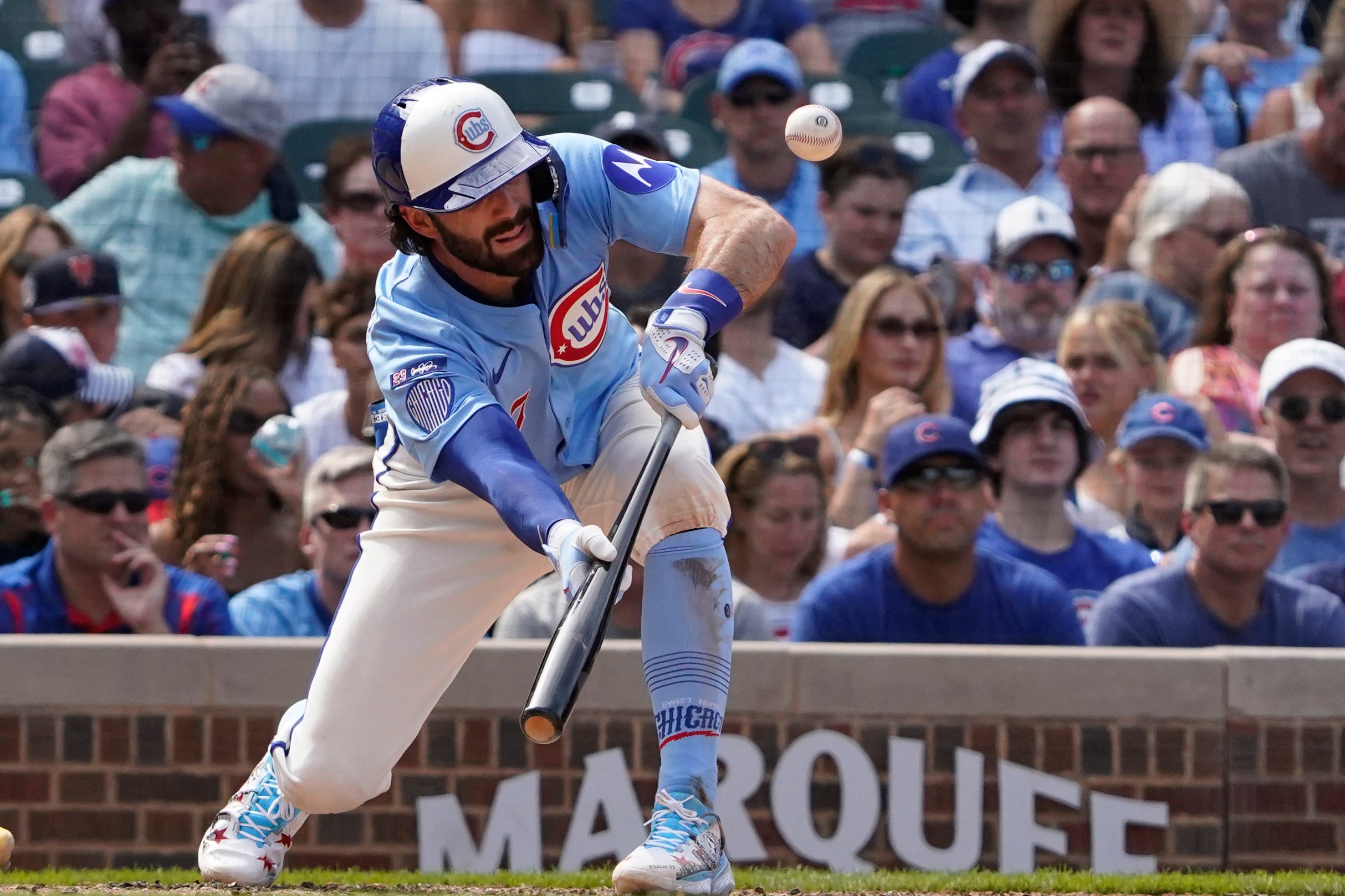 Aug 15, 2025; Chicago, Illinois, USA; Chicago Cubs shortstop Dansby Swanson (7) lays down a sacrifice bunt against the Pittsburgh Pirates during the seventh inning at Wrigley Field. Mandatory Credit: David Banks-Imagn Images