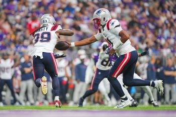 Aug 16, 2025; Minneapolis, Minnesota, USA; New England Patriots quarterback Joshua Dobbs (11) hands the ball off to running back JaMycal Hasty (39) against the Minnesota Vikings in the second quarter at U.S. Bank Stadium. Mandatory Credit: Brad Rempel-Imagn Images