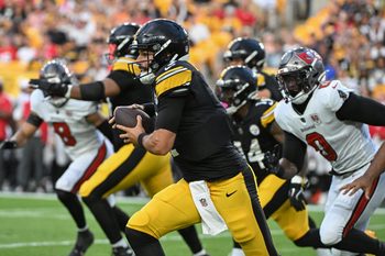 Aug 16, 2025; Pittsburgh, Pennsylvania, USA; Pittsburgh Steelers quarterback Mason Rudolph (2) scrambles away from Tampa Bay Buccaneers linebacker Yaya Diaby (0) during the first quarter at Acrisure Stadium. Mandatory Credit: Barry Reeger-Imagn Images