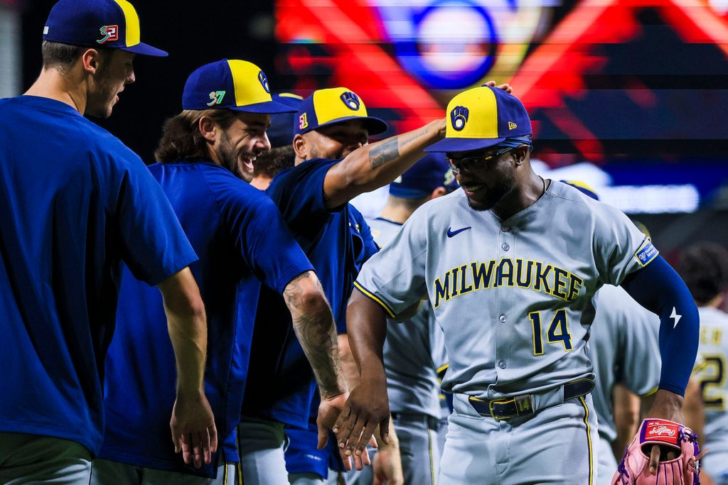 Aug 16, 2025; Cincinnati, Ohio, USA; Milwaukee Brewers outfielder Andruw Monasterio (14) high fives teammates after the victory over the Cincinnati Reds at Great American Ball Park. Mandatory Credit: Katie Stratman-Imagn Images