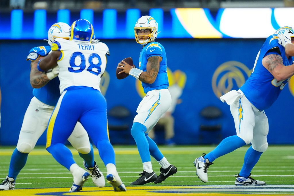 Aug 16, 2025; Inglewood, California, USA; Los Angeles Chargers quarterback Trey Lance (5) throws a pass against the Los Angeles Rams in the second half at SoFi Stadium. Mandatory Credit: Kirby Lee-Imagn Images