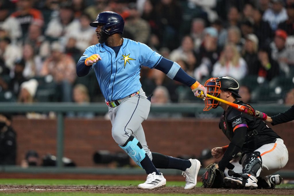 Aug 16, 2025; San Francisco, California, USA; Tampa Bay Rays designated hitter Yandy Diaz (2) hits an RBI single against the San Francisco Giants during the eighth inning at Oracle Park. Mandatory Credit: Darren Yamashita-Imagn Images