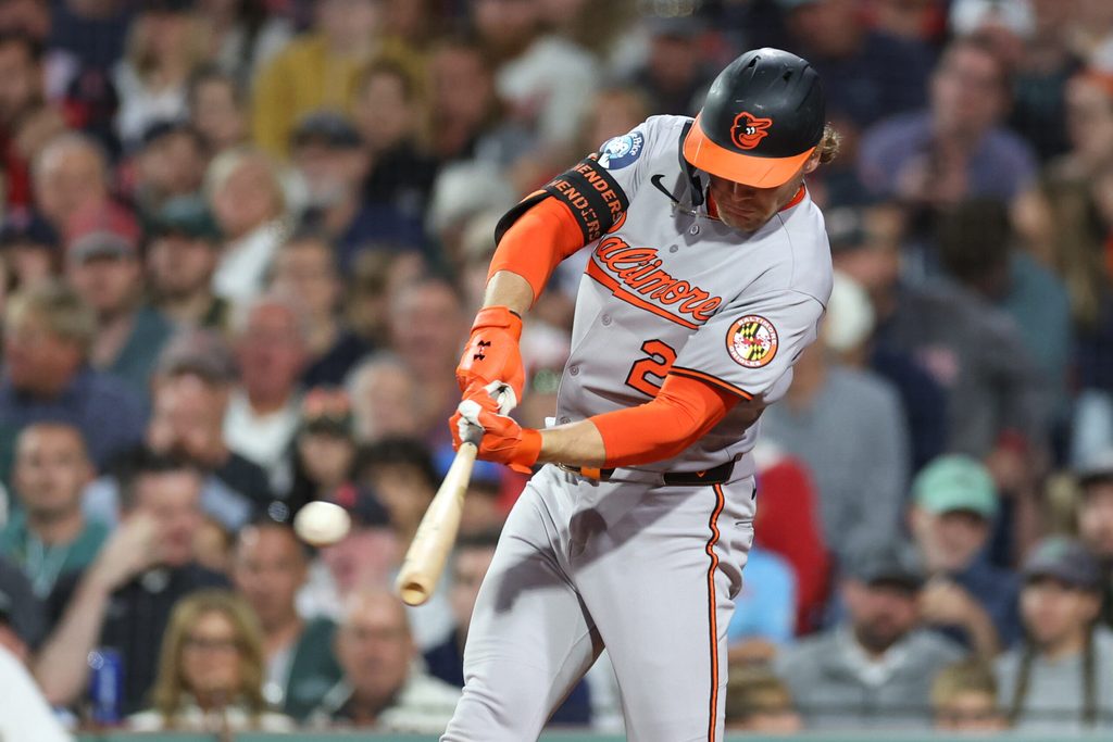 Aug 18, 2025; Boston, Massachusetts, USA; Baltimore Orioles shortstop Gunnar Henderson (2) hits an RBI triple during the seventh inning against the Boston Red Sox at Fenway Park. Mandatory Credit: Paul Rutherford-Imagn Images