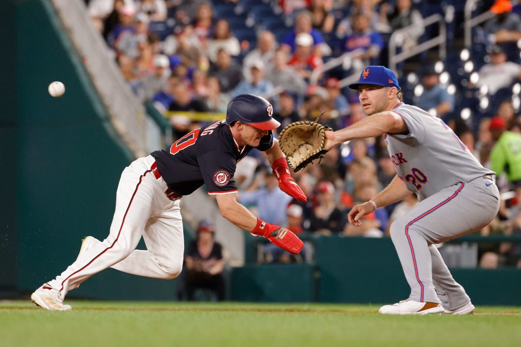 Aug 19, 2025; Washington, District of Columbia, USA; Washington Nationals outfielder Jacob Young (30) returns to first base ahead of a pickoff attempt throw to New York Mets first base Pete Alonso (20) during the sixth inning at Nationals Park. Mandatory Credit: Amber Searls-Imagn Images