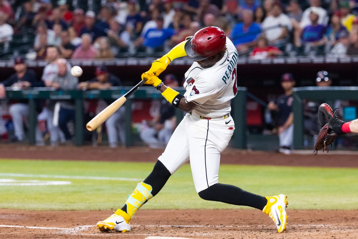 Aug 19, 2025; Phoenix, Arizona, USA; Arizona Diamondbacks infielder Geraldo Perdomo hits an RBI single in the fifth inning against the Cleveland Guardians at Chase Field. Mandatory Credit: Mark J. Rebilas-Imagn Images