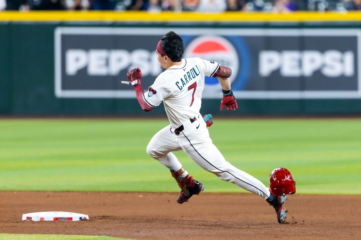 Aug 19, 2025; Phoenix, Arizona, USA; Arizona Diamondbacks outfielder Corbin Carroll loses his helmet as he runs the bases after hitting a triple in the fourth inning against the Cleveland Guardians at Chase Field. Mandatory Credit: Mark J. Rebilas-Imagn Images