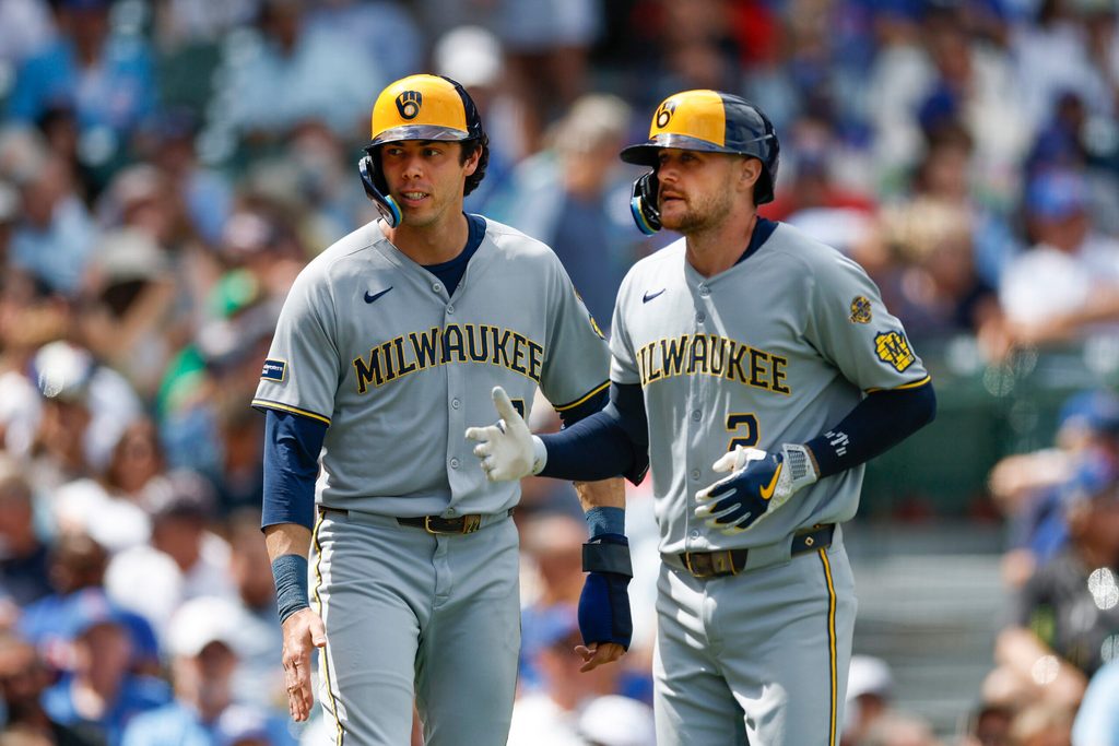Aug 21, 2025; Chicago, Illinois, USA; Milwaukee Brewers second baseman Brice Turang (2) celebrates with designated hitter Christian Yelich (22) after hitting a two-run home run against the Chicago Cubs during the second inning at Wrigley Field. Mandatory Credit: Kamil Krzaczynski-Imagn Images