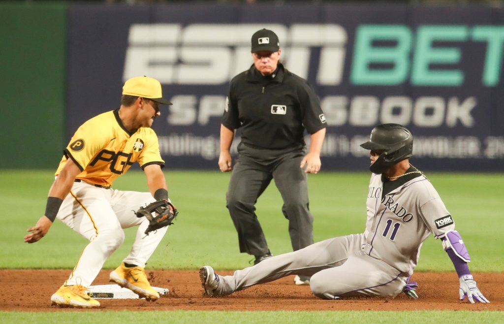 Aug 22, 2025; Pittsburgh, Pennsylvania, USA; Colorado Rockies shortstop Orlando Arcia (11) slides safely into second base as Pittsburgh Pirates second baseman Nick Gonzales (39) attempts a tag during the sixth inning at PNC Park. Mandatory Credit: Charles LeClaire-Imagn Images