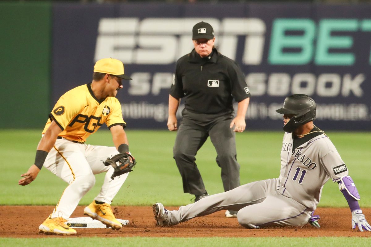 Aug 22, 2025; Pittsburgh, Pennsylvania, USA; Colorado Rockies shortstop Orlando Arcia (11) slides safely into second base as Pittsburgh Pirates second baseman Nick Gonzales (39) attempts a tag during the sixth inning at PNC Park. Mandatory Credit: Charles LeClaire-Imagn Images