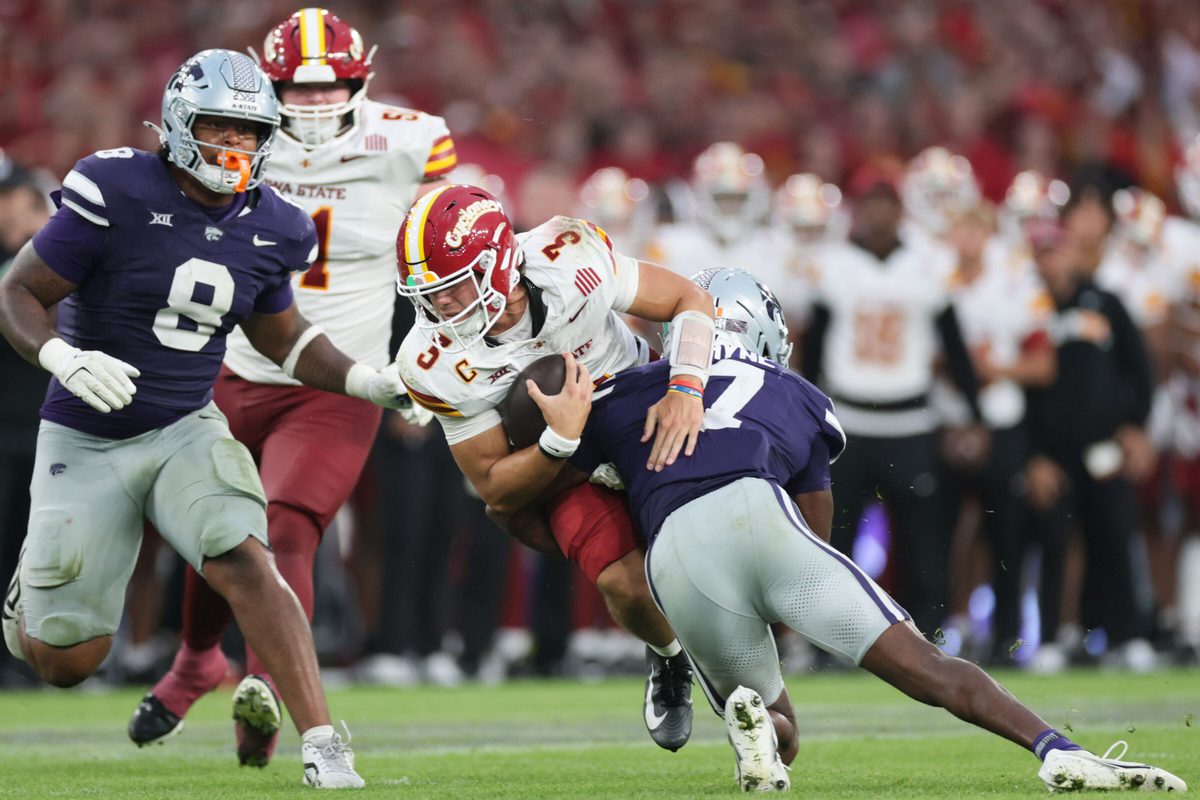 Aug 23, 2025; Dublin, IRELAND; Iowa State quarterback Rocco Becht is tackled by VJ Payne of Kansas State during the Aer Lingus Classic between Iowa State and Kansas State at Aviva Stadium. Mandatory Credit: Laszlo Geczo/INPHO via Imagn Images