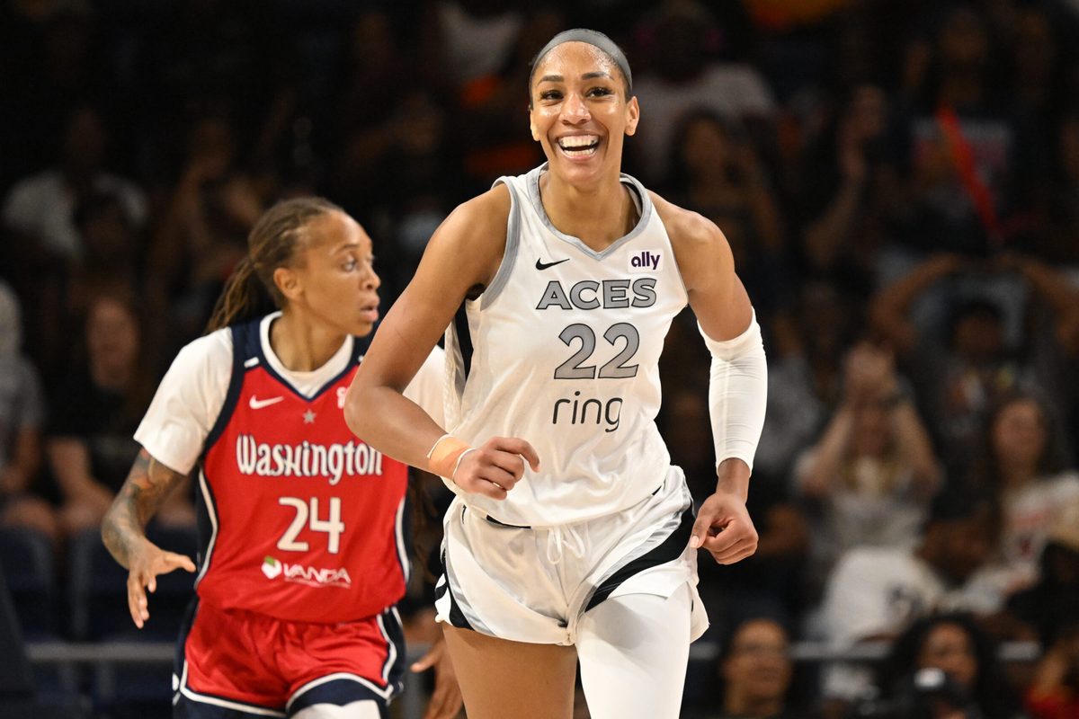 Aug 23, 2025; Washington, District of Columbia, USA; Las Vegas Aces center A'ja Wilson (22) is all smiles after a basket against the Washington Mystics during the fourth quarter at CareFirst Arena. Mandatory Credit: Rafael Suanes-Imagn Images