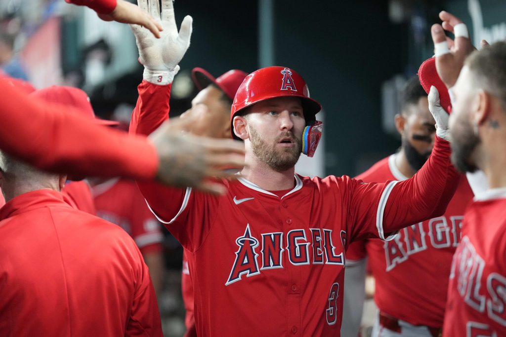 Aug 25, 2025; Arlington, Texas, USA; Los Angeles Angels designated hitter Logan O'Hoppe (14) celebrates his solo home run with teammates in the dugout against the Texas Rangers during the ninth inning at Globe Life Field. Mandatory Credit: Jim Cowsert-Imagn Images