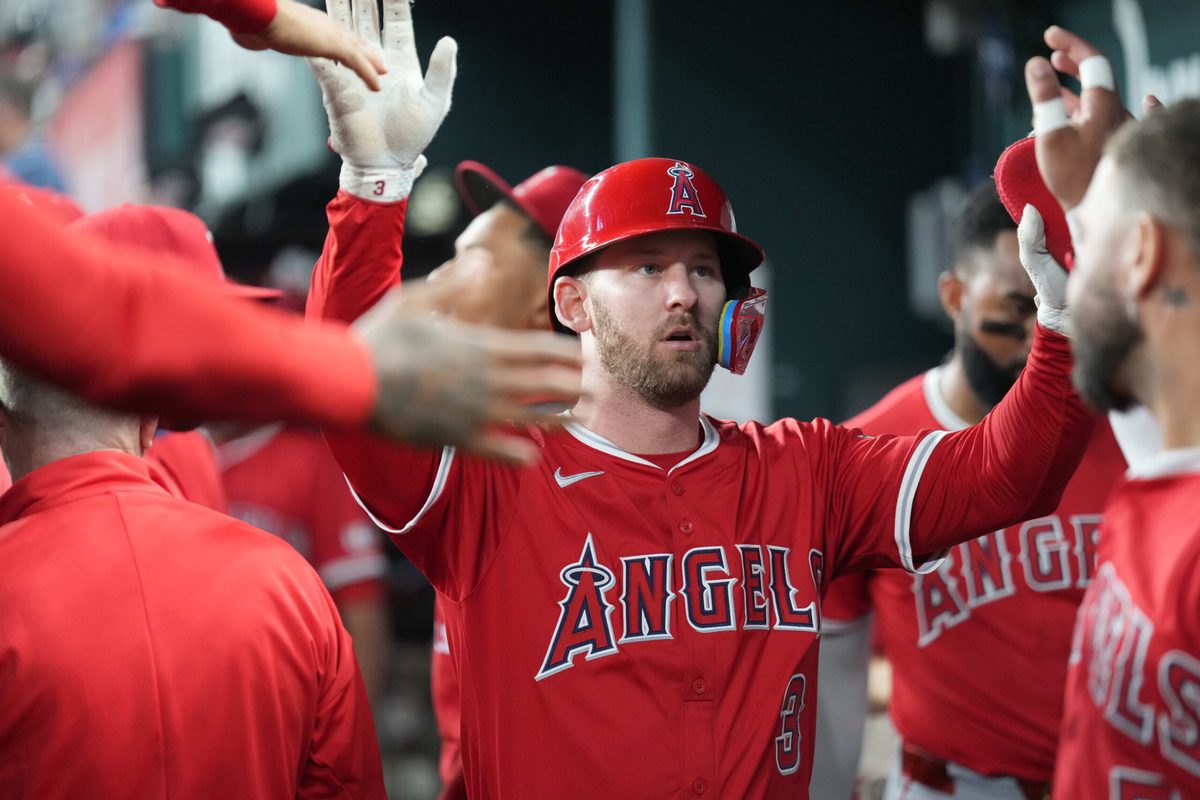 Aug 25, 2025; Arlington, Texas, USA; Los Angeles Angels designated hitter Logan O'Hoppe (14) celebrates his solo home run with teammates in the dugout against the Texas Rangers during the ninth inning at Globe Life Field. Mandatory Credit: Jim Cowsert-Imagn Images