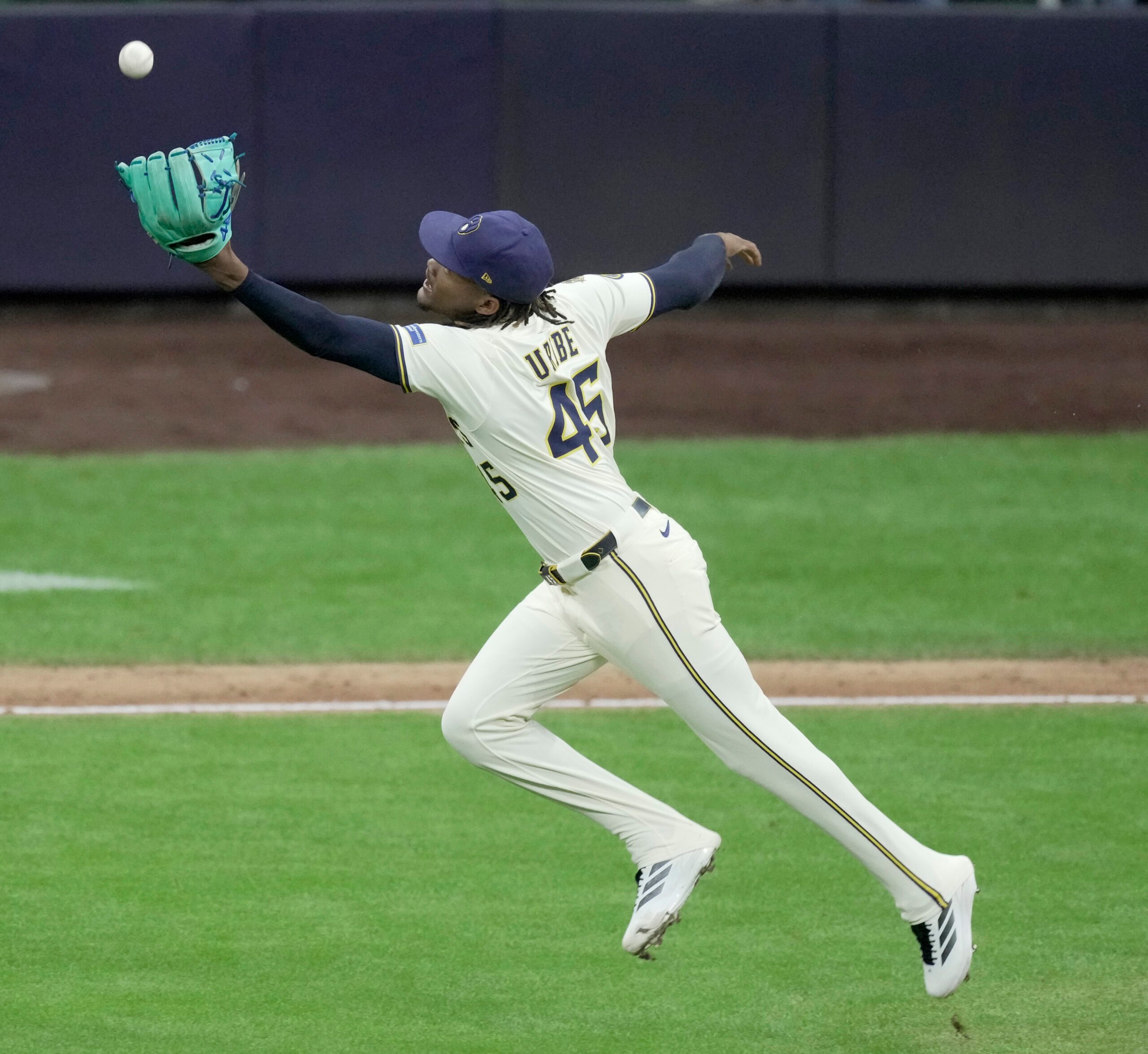 Aug 25, 2025; Milwaukee, Wisconsin, USA; Milwaukee Brewers pitcher Abner Uribe (45) fields and make the throw for the final out during the ninth inning of their game against the Arizona Diamondbacks at American Family Field. Mandatory Credit: Mark Hoffman/USA Today Network via Imagn Images