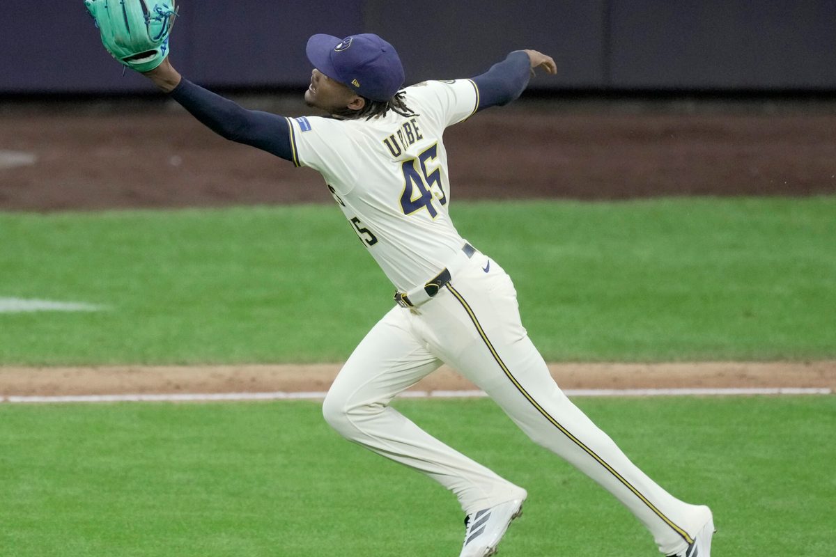Aug 25, 2025; Milwaukee, Wisconsin, USA; Milwaukee Brewers pitcher Abner Uribe (45) fields and make the throw for the final out during the ninth inning of their game against the Arizona Diamondbacks at American Family Field. Mandatory Credit: Mark Hoffman/USA Today Network via Imagn Images
