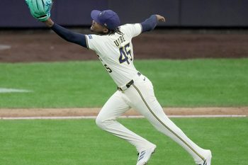 Aug 25, 2025; Milwaukee, Wisconsin, USA; Milwaukee Brewers pitcher Abner Uribe (45) fields and make the throw for the final out during the ninth inning of their game against the Arizona Diamondbacks at American Family Field. Mandatory Credit: Mark Hoffman/USA Today Network via Imagn Images