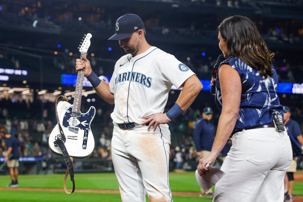 Aug 25, 2025; Seattle, Washington, USA; Seattle Mariners catcher Cal Raleigh (29) holds the “Vedder Cup” trophy for the winning the season series against the San Diego Padres following a victory Padres at T-Mobile Park. The “Vedder Cup” is named after Pearl Jam frontman Eddie Vedder. Mandatory Credit: Joe Nicholson-Imagn Images