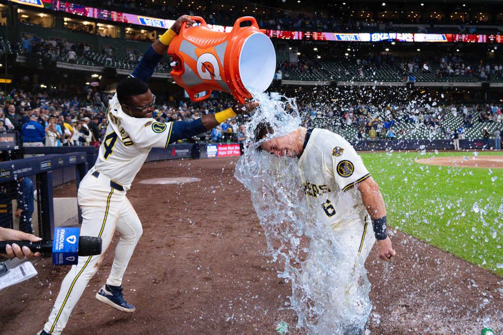 Aug 26, 2025; Milwaukee, Wisconsin, USA; Milwaukee Brewers left fielder Isaac Collins (6) is dunked with Gatorade by Andruw Monasterio (14) after driving in the winning run during the ninth inning against the Arizona Diamondbacks at American Family Field. Mandatory Credit: Jeff Hanisch-Imagn Images
