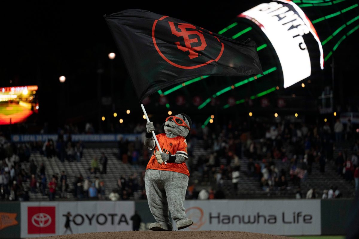 Aug 27, 2025; San Francisco, California, USA; San Francisco Giants mascot Lou Seal celebrates after defeating the Chicago Cubs at Oracle Park. Mandatory Credit: Stan Szeto-Imagn Images