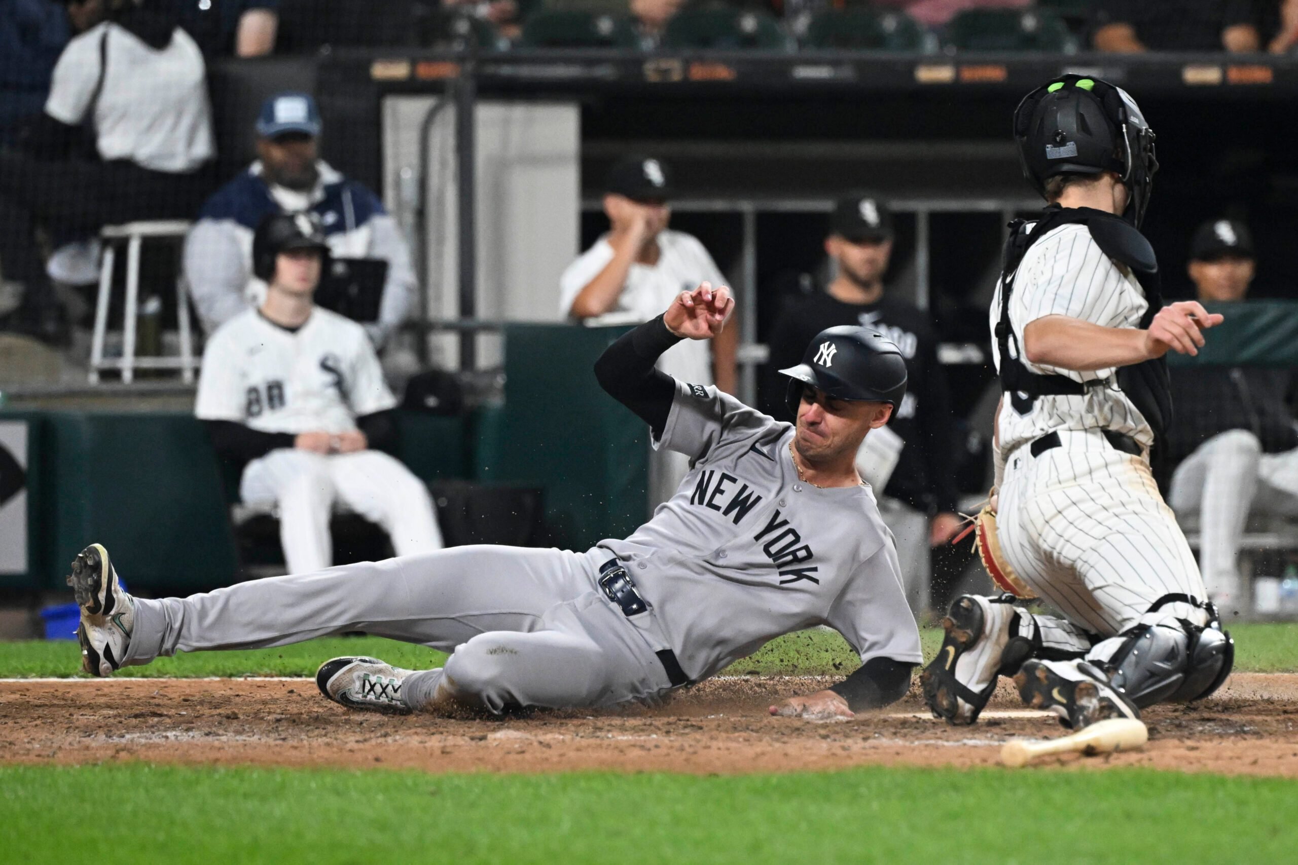 Aug 28, 2025; Chicago, Illinois, USA; New York Yankees outfielder Cody Bellinger (35) slides safely past Chicago White Sox catcher Kyle Teel (8) during the ninth inning at Rate Field. Mandatory Credit: Matt Marton-Imagn Images