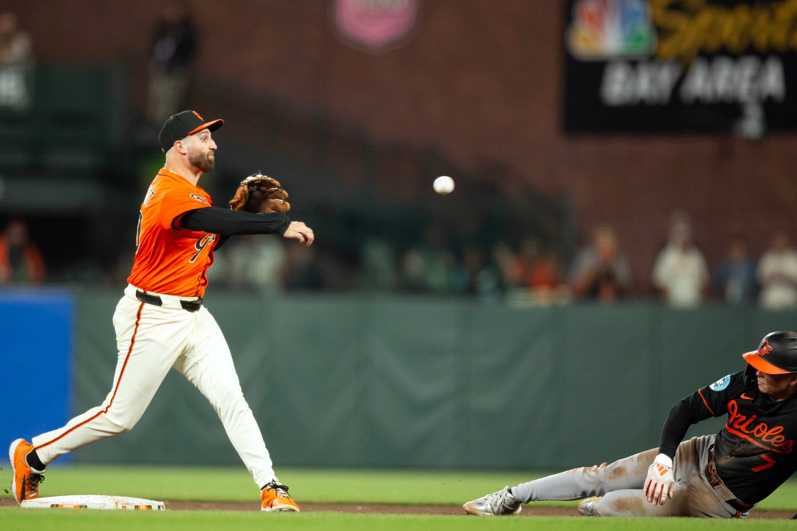 Aug 29, 2025; San Francisco, California, USA; San Francisco Giants second baseman Casey Schmitt (10) throws over Baltimore Orioles second baseman Jackson Holliday (7) too late to complete a double play during the ninth inning at Oracle Park. Mandatory Credit: D. Ross Cameron-Imagn Images