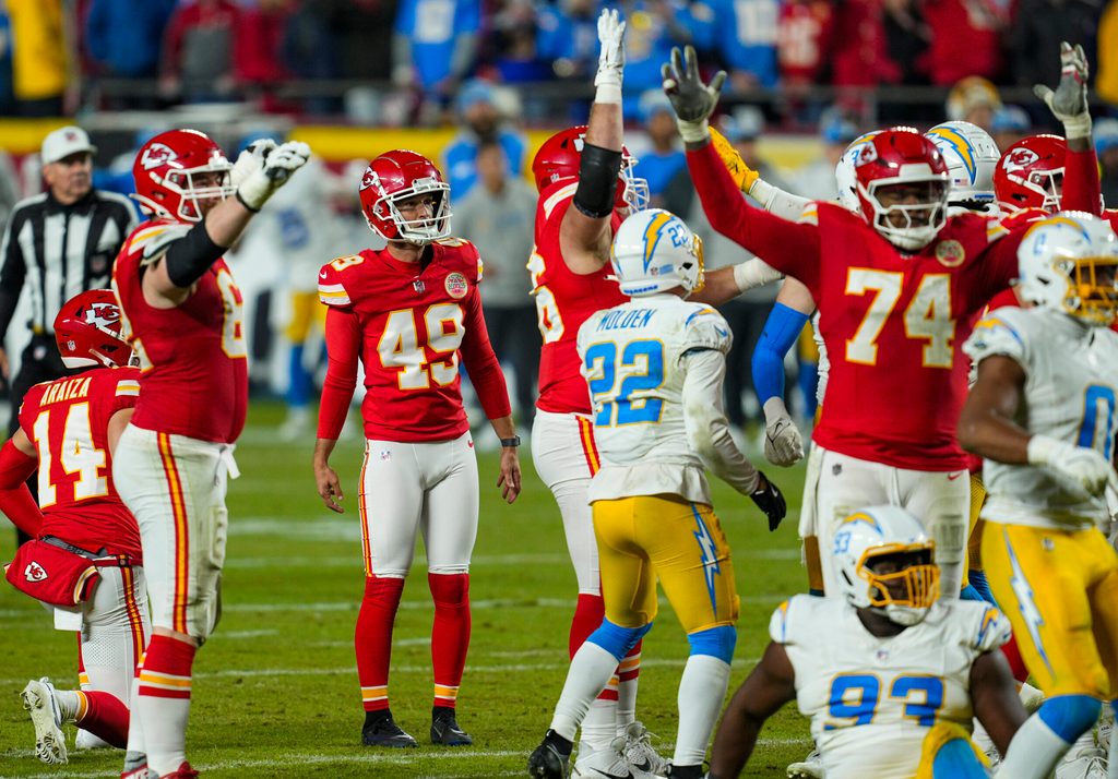 Dec 8, 2024; Kansas City, Missouri, USA; Kansas City Chiefs place kicker Matthew Wright (49) watches a game winning field goal as time expires against the Los Angeles Chargers at GEHA Field at Arrowhead Stadium. Mandatory Credit: Jay Biggerstaff-Imagn Images