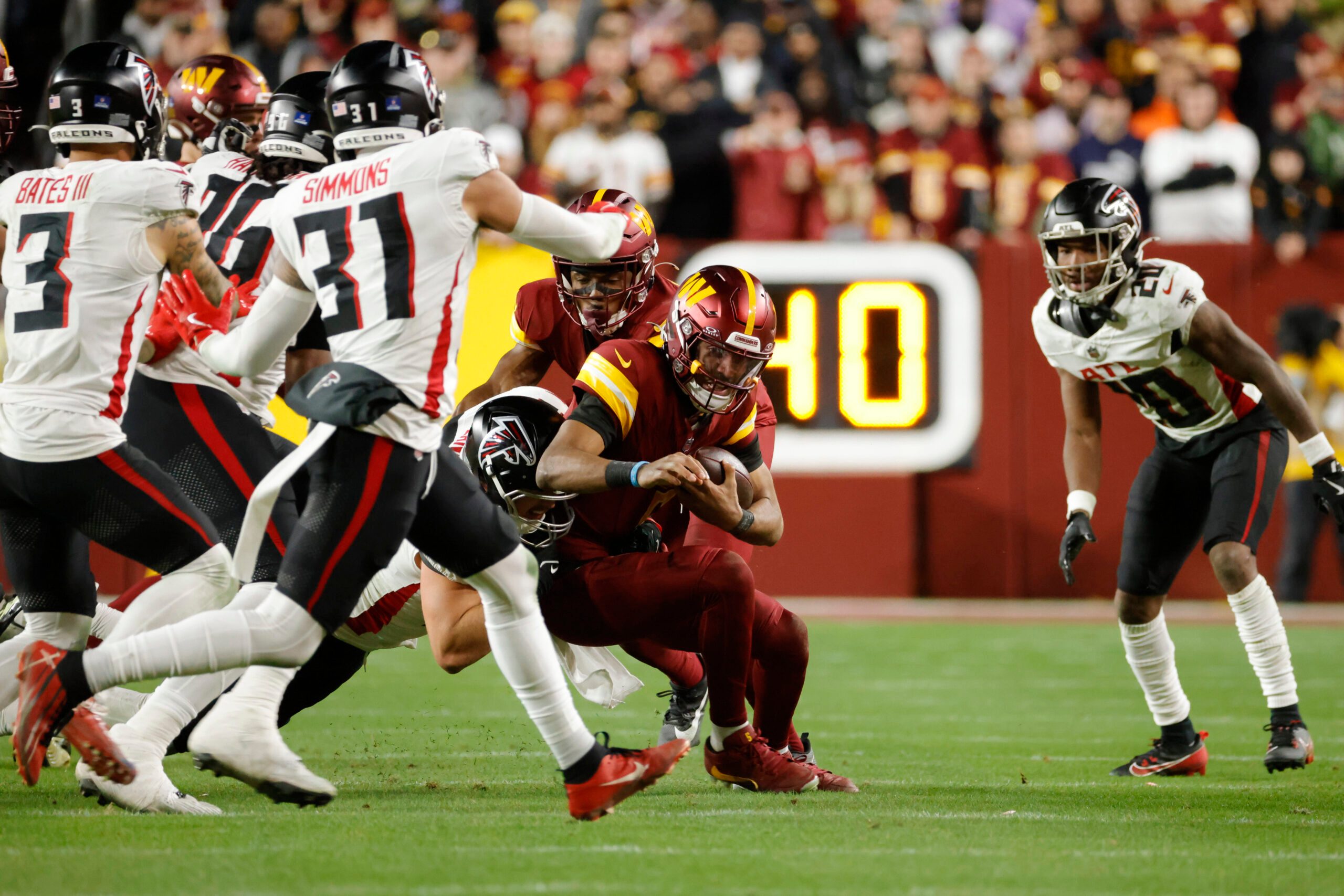 Dec 29, 2024; Landover, Maryland, USA; Washington Commanders quarterback Jayden Daniels (5) runs with the ball against the Atlanta Falcons during the second half at Northwest Stadium. Mandatory Credit: Amber Searls-Imagn Images