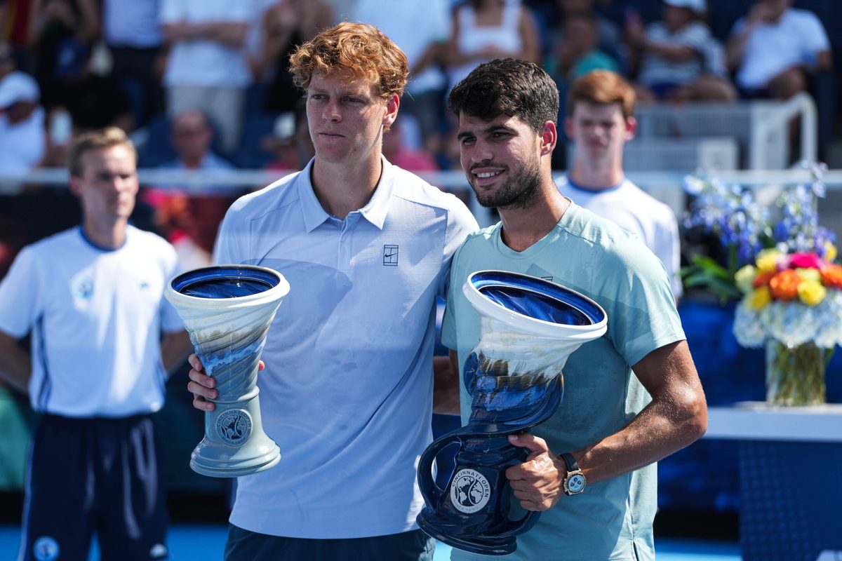 Carlos Alcaraz (right) accepts his award after winning the Men's Singles Finals match against Jannik Sinner (left) at the Cincinnati Open in Mason, Ohio on Monday August 18, 2025. Sinner retired due to illness after losing five games to Alcaraz.
