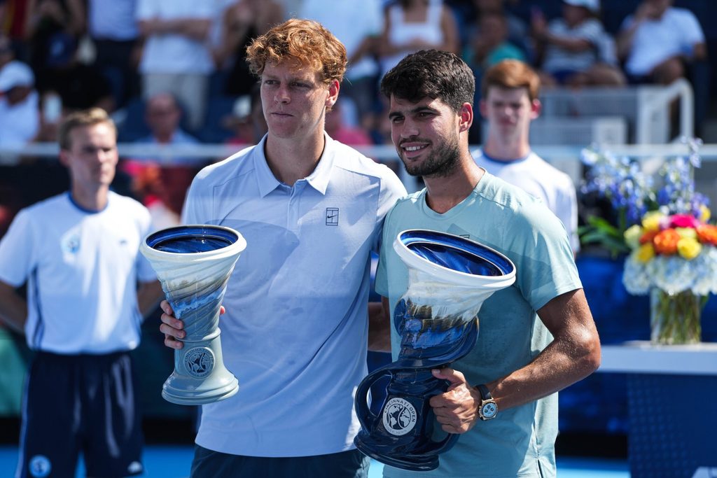Carlos Alcaraz (right) accepts his award after winning the Men's Singles Finals match against Jannik Sinner (left) at the Cincinnati Open in Mason, Ohio on Monday August 18, 2025. Sinner retired due to illness after losing five games to Alcaraz.