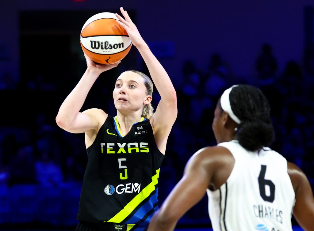 Aug 24, 2025; Arlington, Texas, USA; Dallas Wings guard Paige Bueckers (5) shoots over Golden State Valkyries guard Kaila Charles (6) during the second half at College Park Center. Mandatory Credit: Kevin Jairaj-Imagn Images