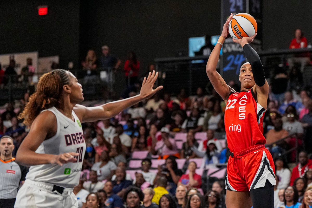 Aug 27, 2025; College Park, Georgia, USA; Las Vegas Aces center A'ja Wilson (22) shoots over Atlanta Dream forward Naz Hillmon (00) during the first half at Gateway Center Arena at College Park. Mandatory Credit: Dale Zanine-Imagn Images
