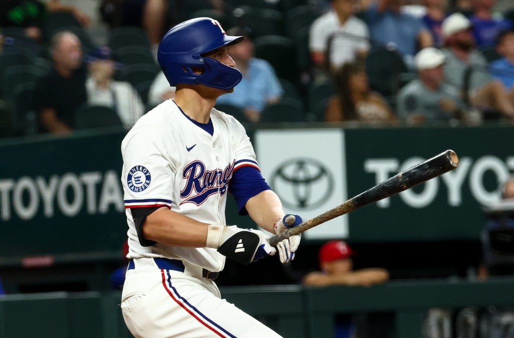 Aug 27, 2025; Arlington, Texas, USA; Texas Rangers shortstop Corey Seager (5) hits a two-run home run during the fourth inning against the Los Angeles Angels at Globe Life Field. Mandatory Credit: Kevin Jairaj-Imagn Images