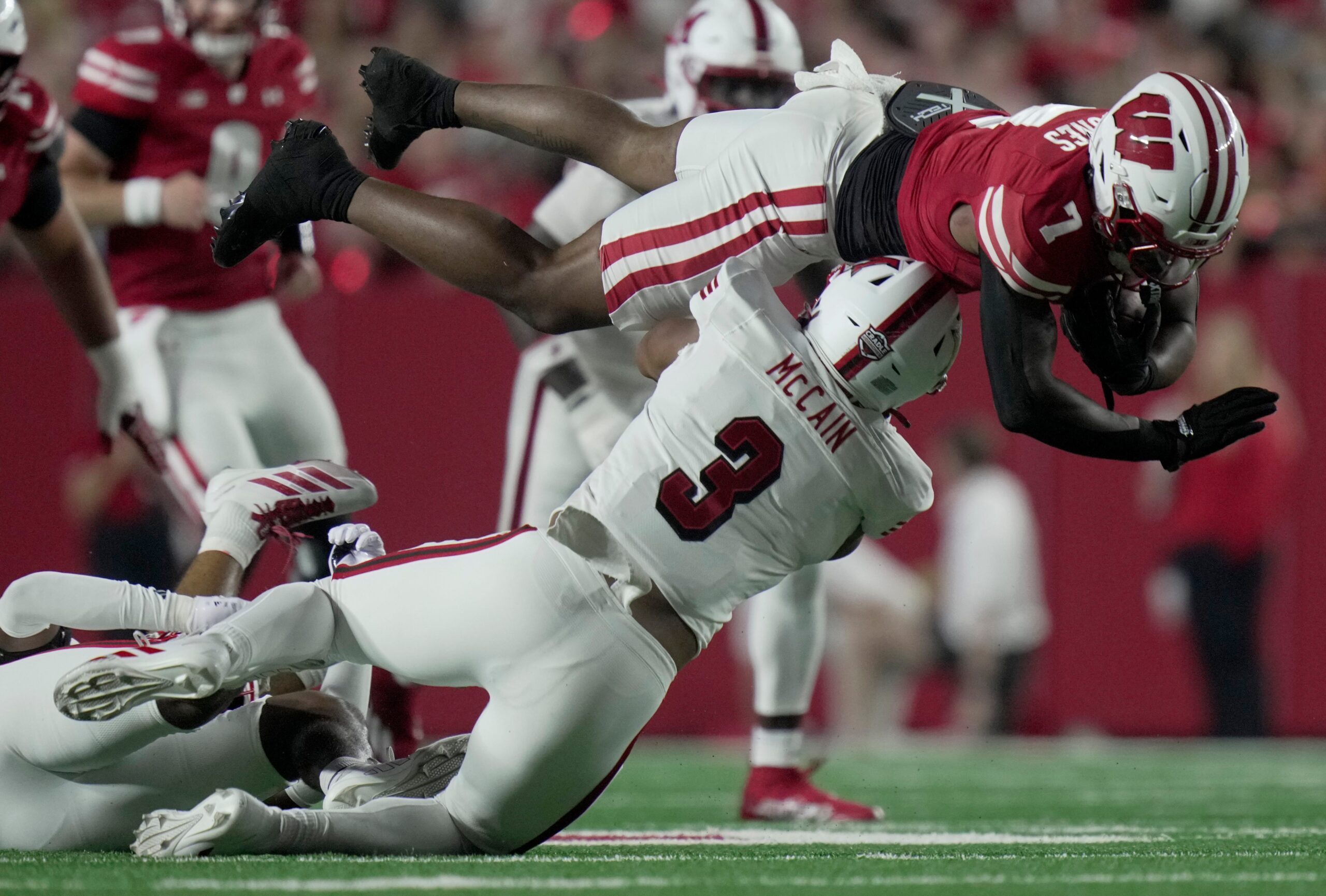Wisconsin running back Dilin Jones (7) is tackled by Miami (Ohio) linebacker Malcolm McCain (3) after picking a first down during the first quarter of their game Thursday, August 28, 2025 at Camp Randall Stadium in Madison, Wisconsin.