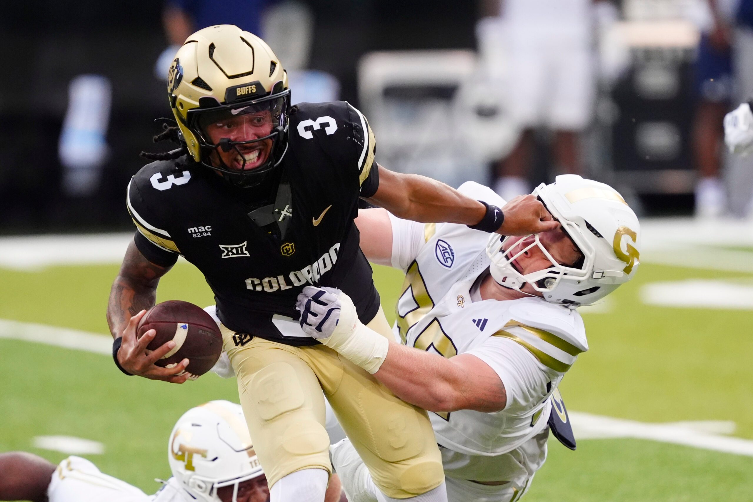 Aug 29, 2025; Boulder, Colorado, USA; Colorado Buffaloes quarterback Kaidon Salter (3) stiff arms Georgia Tech Yellow Jackets defensive lineman Jordan van den Berg (99) in the second quarter at Folsom Field. Mandatory Credit: Ron Chenoy-Imagn Images