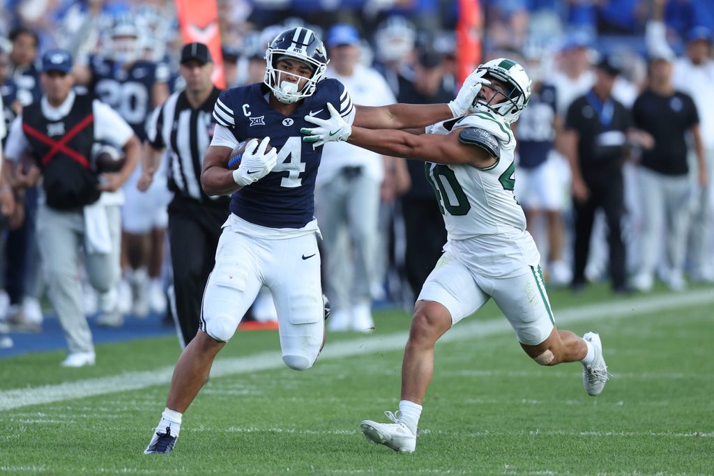 Aug 30, 2025; Provo, Utah, USA; Brigham Young Cougars running back LJ Martin (4) runs the ball against Portland State Vikings linebacker Lonnie Burt (40) during the second quarter at LaVell Edwards Stadium. Mandatory Credit: Rob Gray-Imagn Images