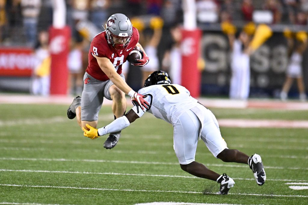 Aug 30, 2025; Pullman, Washington, USA; Washington State Cougars running back Kirby Vorhees (9) tries to jump pass Idaho Vandals defensive back Jhamell Blenman (0) in the second half at Gesa Field at Martin Stadium. Washington State Cougars won 13-10. Mandatory Credit: James Snook-Imagn Images