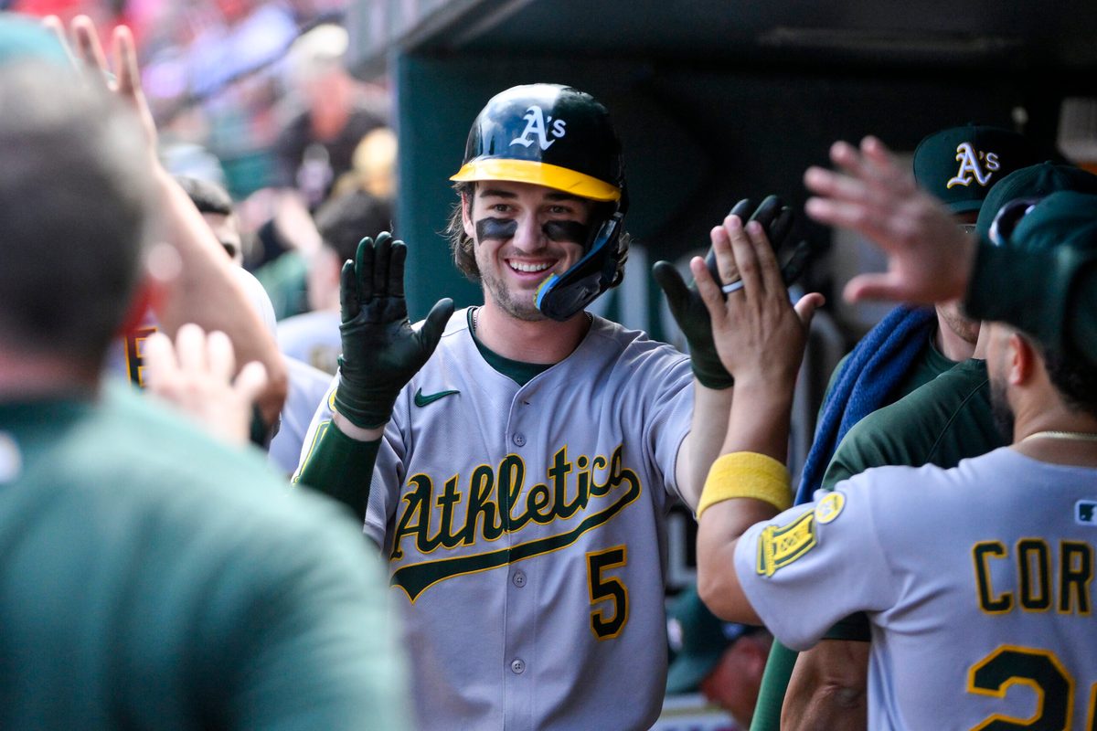 Sep 1, 2025; St. Louis, Missouri, USA; Athletics shortstop Jacob Wilson (5) is congratulated by teammates after scoring against the St. Louis Cardinals during the seventh inning at Busch Stadium. Mandatory Credit: Jeff Curry-Imagn Images