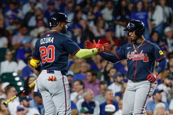Sep 5, 2025; Chicago, Illinois, USA; Atlanta Braves second baseman Ozzie Albies (1) celebrates with designated hitter Marcell Ozuna (20) after hitting a solo home run against the Chicago Cubs during the fourth inning at Wrigley Field. Mandatory Credit: Kamil Krzaczynski-Imagn Images