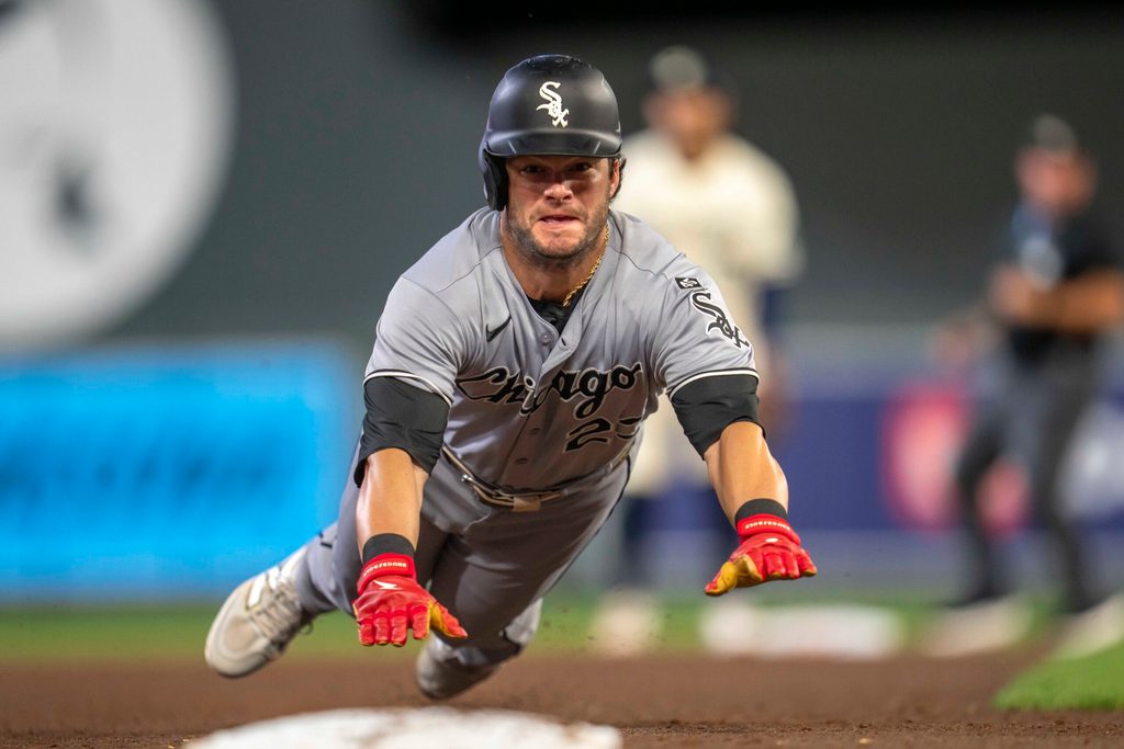 Sep 2, 2025; Minneapolis, Minnesota, USA; Chicago White Sox left fielder Andrew Benintendi (23) slides into third base safely after a fly ball against the Minnesota Twins in the sixth inning at Target Field. Mandatory Credit: Jesse Johnson-Imagn Images