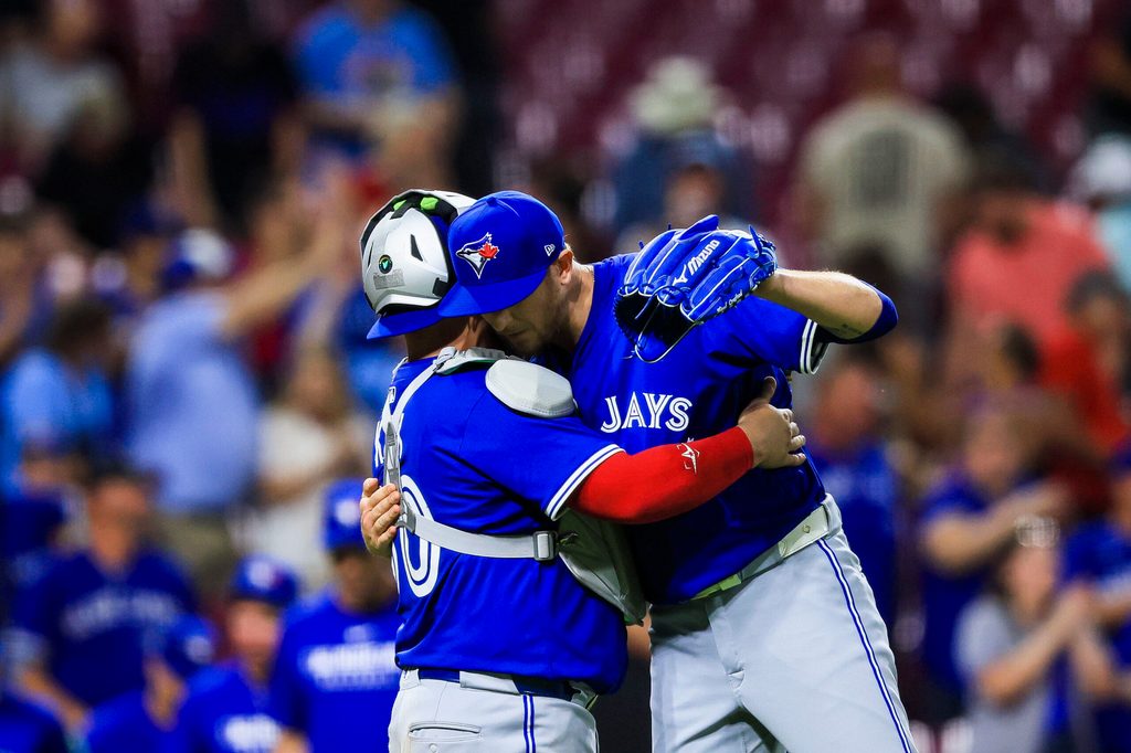 Sep 2, 2025; Cincinnati, Ohio, USA; Toronto Blue Jays catcher Alejandro Kirk (30) hugs relief pitcher Jeff Hoffman (23) after the victory over the Cincinnati Reds at Great American Ball Park. Mandatory Credit: Katie Stratman-Imagn Images