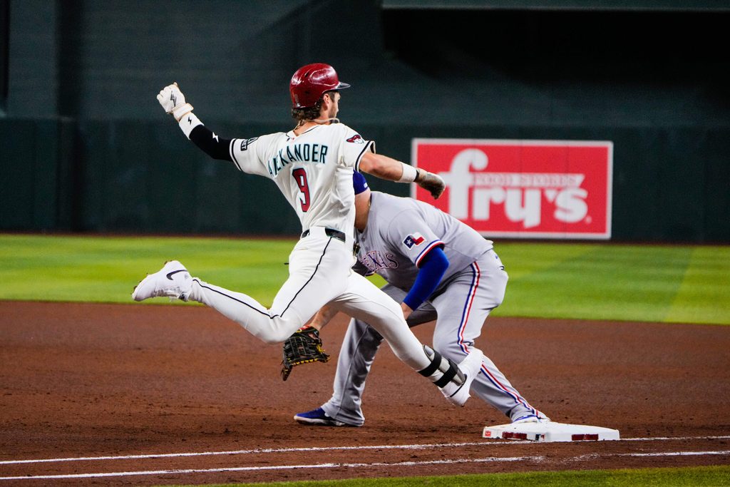 Sep 2, 2025; Phoenix, Arizona, USA; Arizona Diamondbacks shortstop Blaze Alexander (9) gets safely on base in the fourth inning of the game between Arizona Diamondbacks and Texas Rangers at Chase Field. Mandatory Credit: Arianna Grainey-Imagn Images