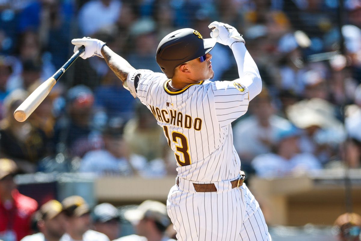 Sep 3, 2025; San Diego, California, USA; San Diego Padres third baseman Manny Machado (13) hits a two-run home run during the sixth inning against the Baltimore Orioles at Petco Park. Mandatory Credit: David Frerker-Imagn Images