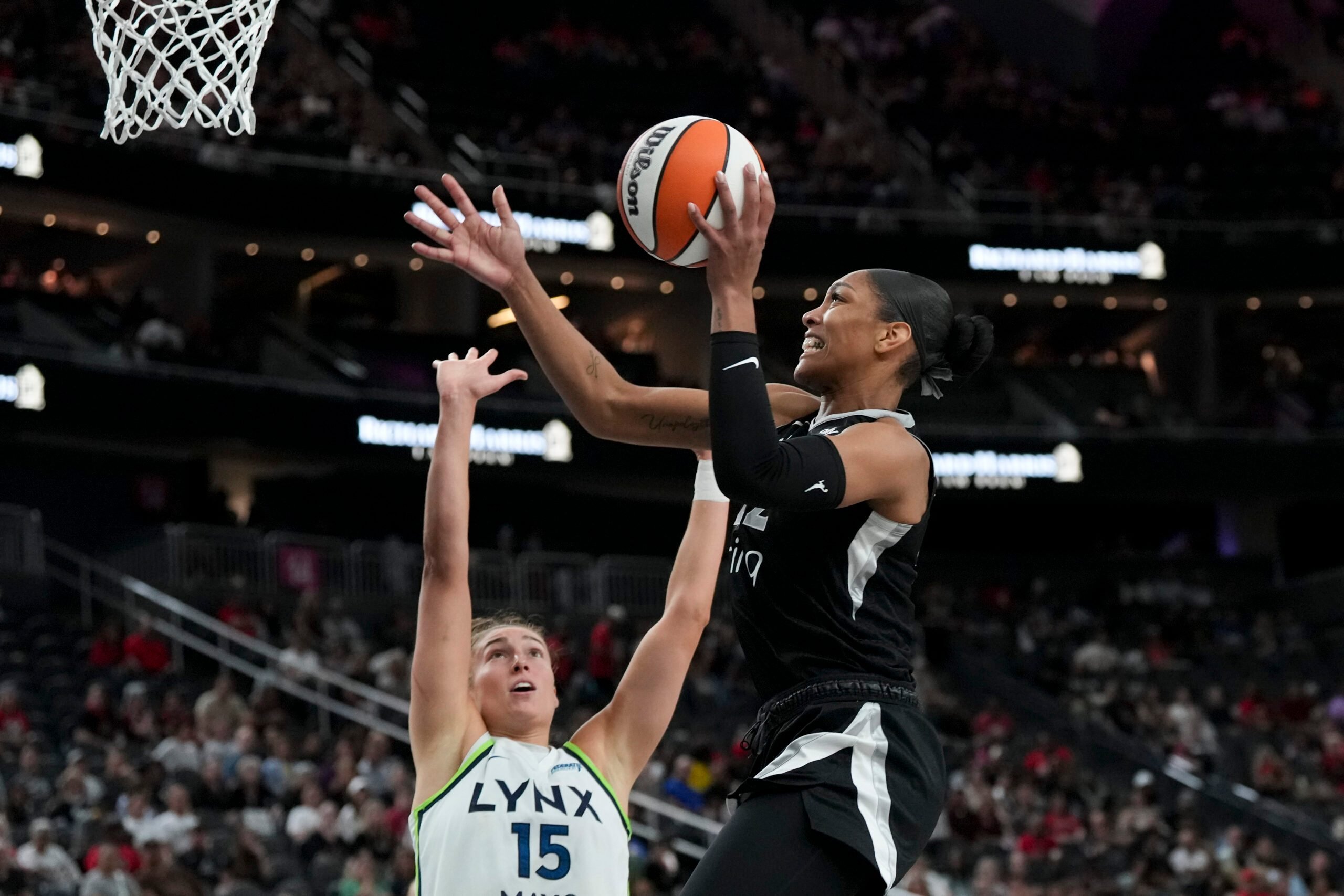 Sep 4, 2025; Las Vegas, Nevada, USA; Las Vegas Aces center A'ja Wilson (22) shoots against Minnesota Lynx forward Jessica Shepard (15) in the second quarter of their game at T-Mobile Arena. Mandatory Credit: Candice Ward-Imagn Images