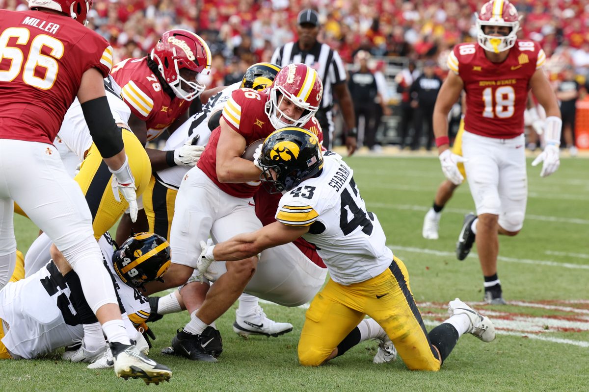 Sep 6, 2025; Ames, Iowa, USA; Iowa Hawkeyes linebacker Karson Sharar (43) tackles Iowa State Cyclones running back Carson Hansen (26) during the second half at Jack Trice Stadium. Mandatory Credit: Reese Strickland-Imagn Images